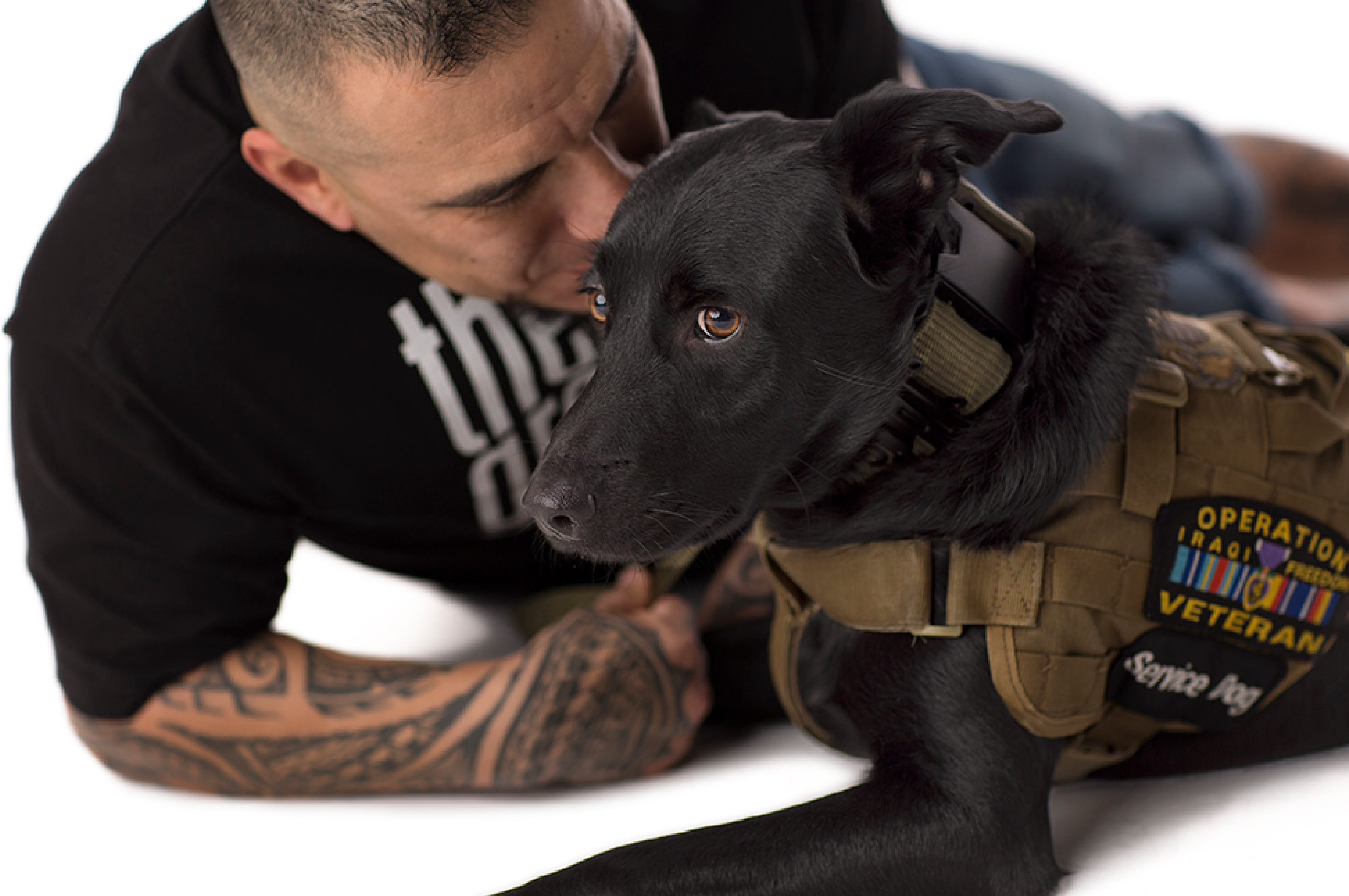 Veteran with his black service dog